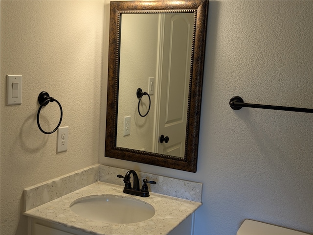 bathroom featuring toilet and vanity