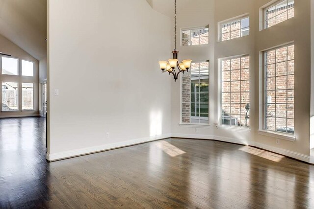 dining room featuring high vaulted ceiling and a notable chandelier