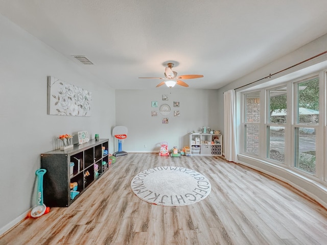 rec room featuring ceiling fan and light hardwood / wood-style flooring