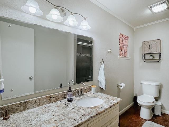 bathroom featuring wood-type flooring, vanity, toilet, walk in shower, and crown molding