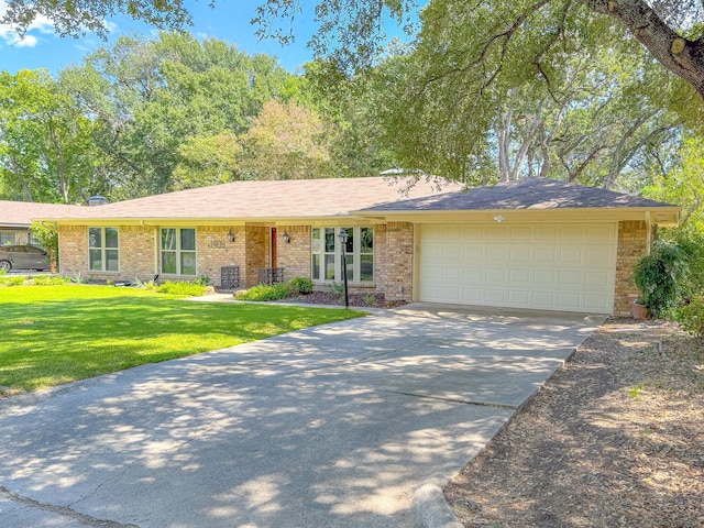 ranch-style house featuring a garage and a front lawn