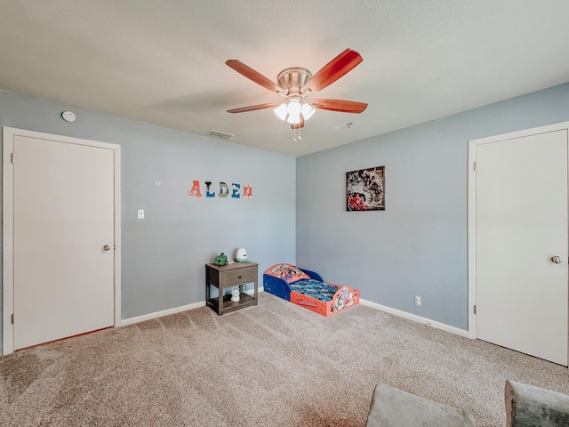 recreation room with ceiling fan and carpet flooring