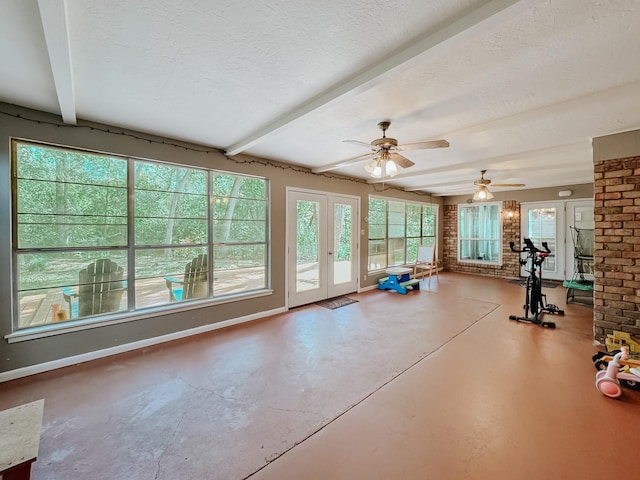 workout room with ceiling fan, french doors, and a textured ceiling