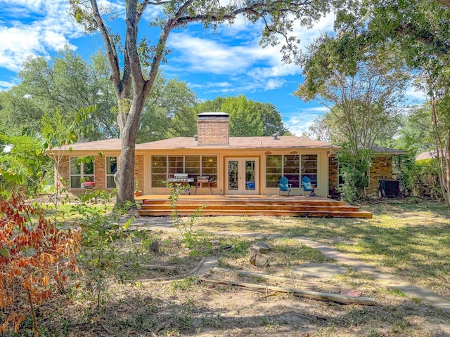 rear view of property featuring french doors and a deck