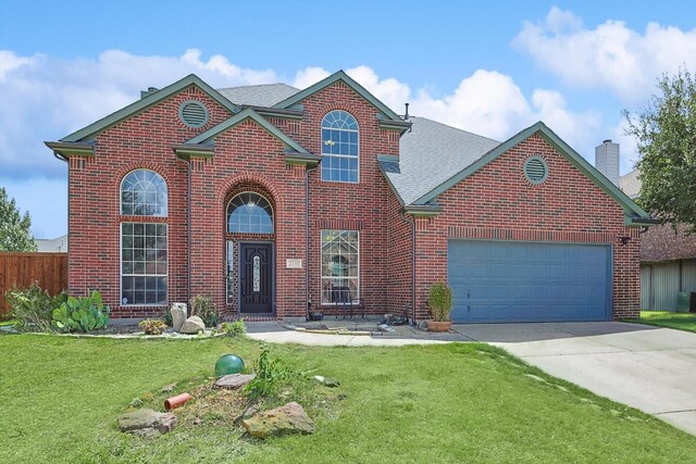 view of front of home with a front lawn and a garage