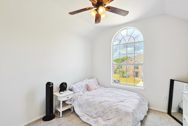 carpeted bedroom featuring lofted ceiling, ceiling fan, and baseboards