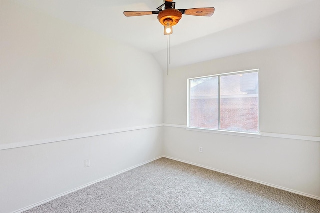 unfurnished room featuring lofted ceiling, baseboards, a ceiling fan, and carpet flooring