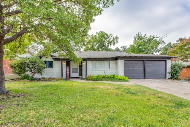 ranch-style home with a garage and a front lawn