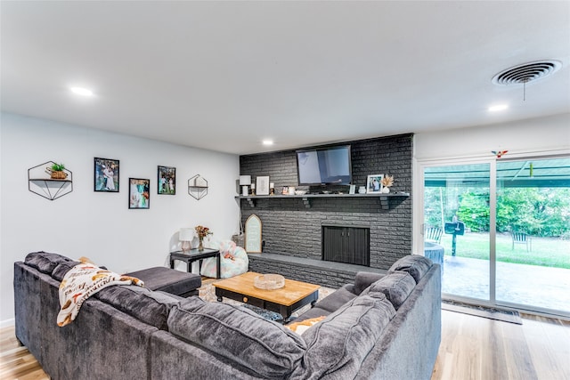 living room featuring light hardwood / wood-style flooring and a fireplace