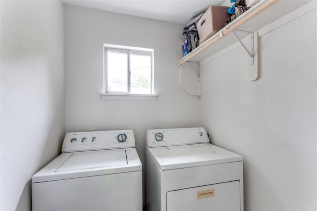 washroom with washing machine and clothes dryer