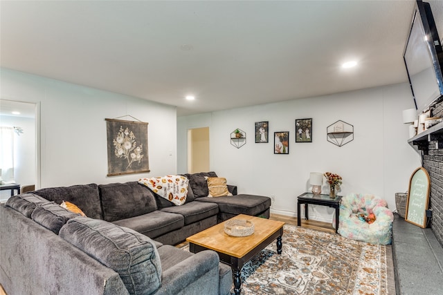 living room with a brick fireplace