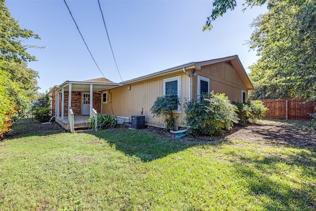 exterior space with a lawn and cooling unit