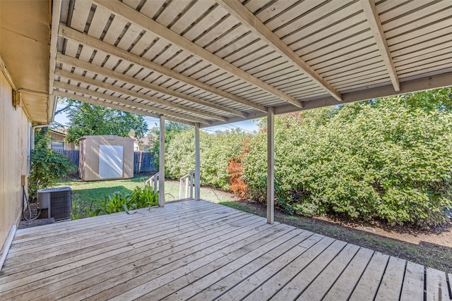 wooden terrace featuring a storage unit and central air condition unit