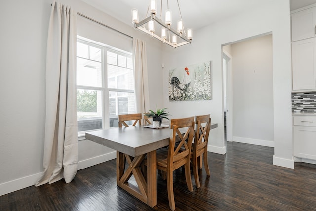 dining space with a chandelier and dark hardwood / wood-style floors