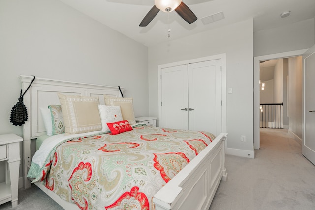 carpeted bedroom featuring ceiling fan and a closet