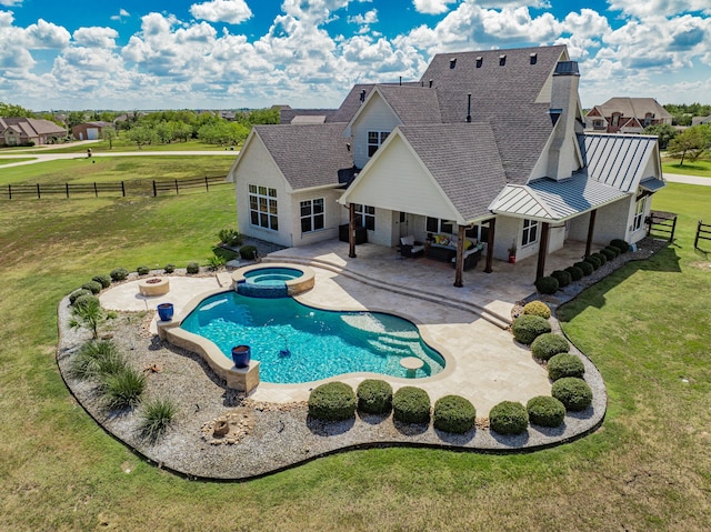 view of pool with an in ground hot tub, a yard, and a patio