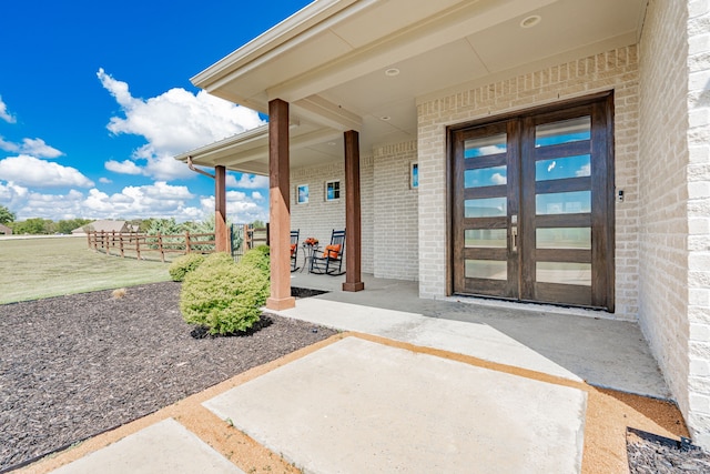 doorway to property with a patio area and french doors