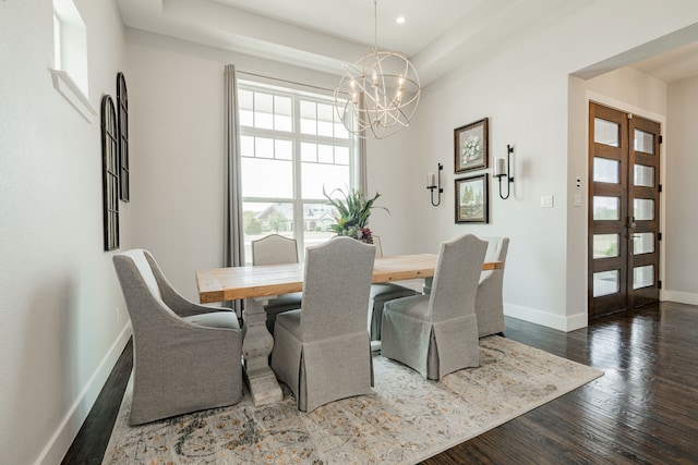 dining area featuring an inviting chandelier, dark hardwood / wood-style flooring, and french doors