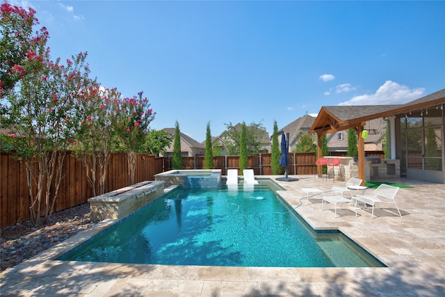 view of pool with a patio area and an in ground hot tub