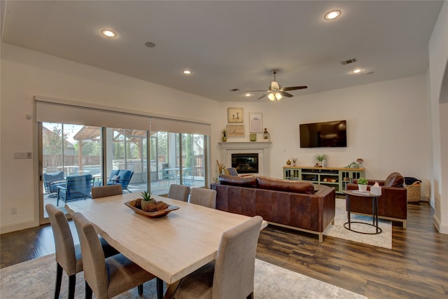 dining space with ceiling fan and dark hardwood / wood-style flooring