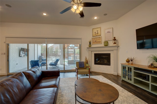 living room featuring dark wood-type flooring and ceiling fan