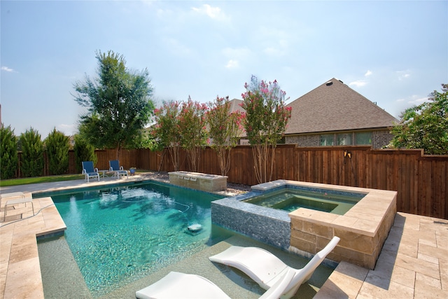 view of swimming pool with a patio area and an in ground hot tub