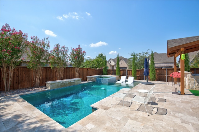 view of swimming pool featuring an in ground hot tub, a patio area, and pool water feature