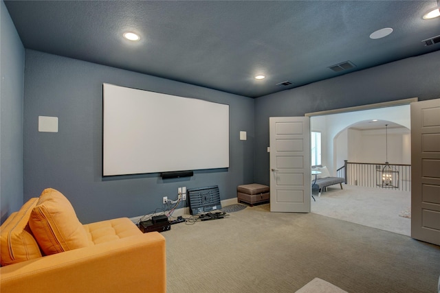 3203 Prancer Way, Celina, TX 75009 - carpeted home theater room featuring arched walkways, visible vents, and recessed lighting