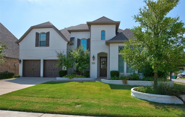 view of front of house with a front yard and a garage