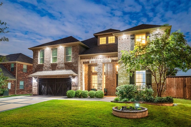 view of front of property featuring a garage and a yard