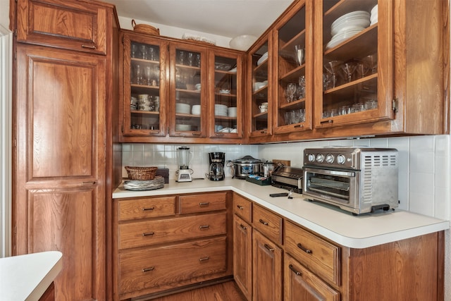 kitchen featuring hardwood / wood-style flooring and backsplash