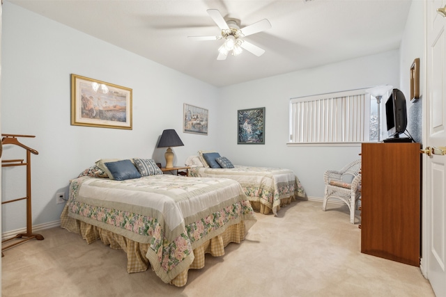 bedroom featuring ceiling fan and light carpet