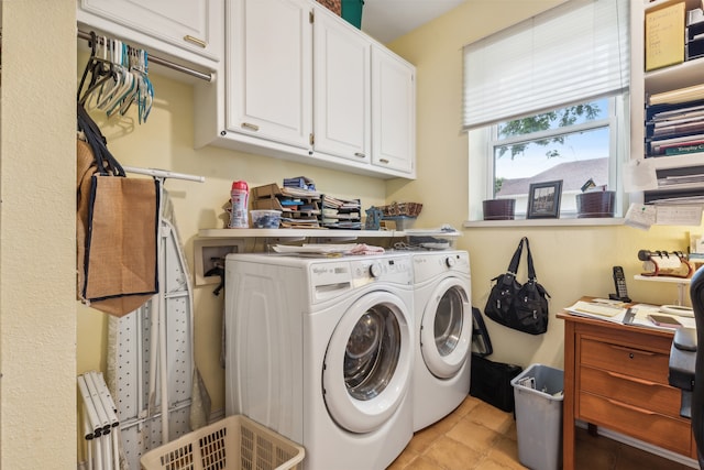 laundry area with light tile patterned floors, cabinets, and washing machine and dryer