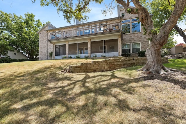 view of front of property featuring a balcony and a front yard