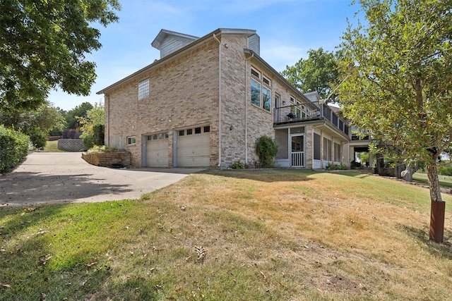 view of home's exterior featuring a lawn and a garage