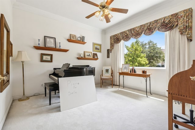 carpeted office featuring crown molding and ceiling fan