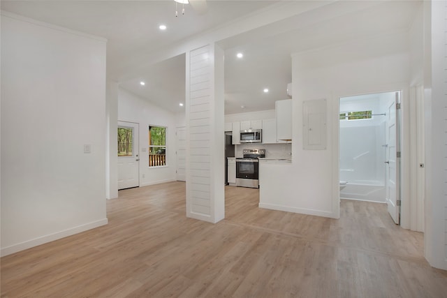 unfurnished living room with vaulted ceiling and light wood-type flooring