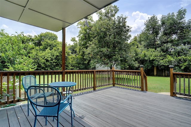 wooden deck featuring a yard