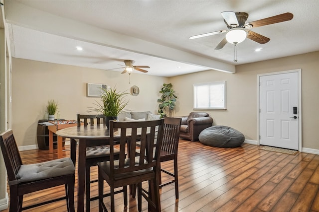 dining area with a textured ceiling, ceiling fan, and hardwood / wood-style floors