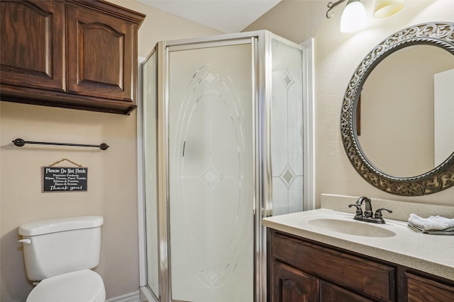 bathroom featuring an enclosed shower, toilet, and vanity