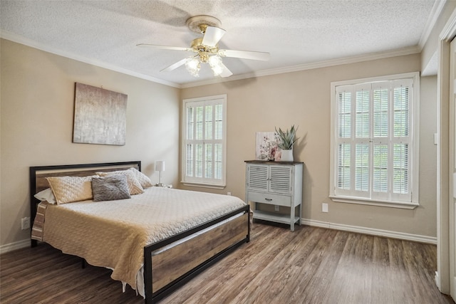 bedroom with multiple windows, dark hardwood / wood-style flooring, ceiling fan, and a textured ceiling