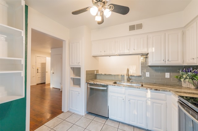 kitchen with sink, appliances with stainless steel finishes, light hardwood / wood-style flooring, and white cabinetry