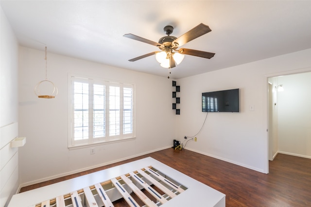 unfurnished bedroom featuring ceiling fan and dark hardwood / wood-style flooring