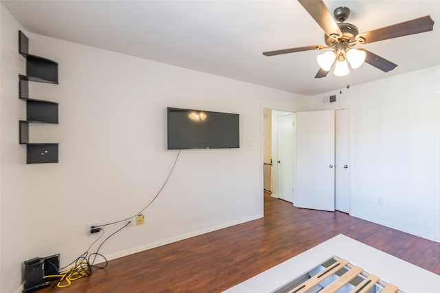 unfurnished bedroom with dark hardwood / wood-style floors and ceiling fan