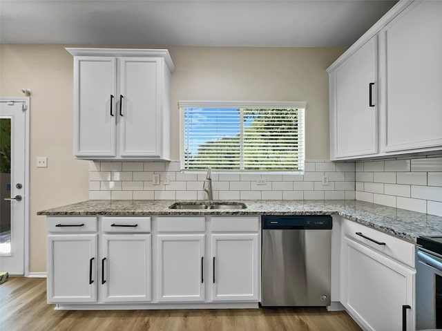 kitchen featuring dishwasher, sink, light wood-type flooring, and white cabinets