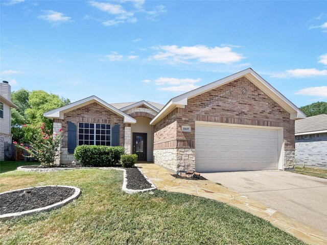 view of front of house featuring a garage and a front yard