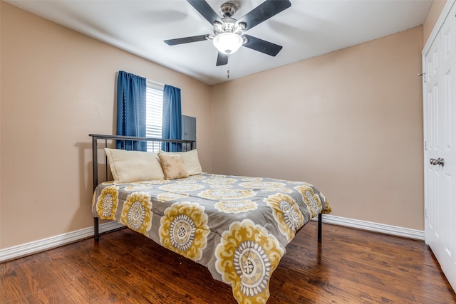 bedroom with a closet, ceiling fan, and dark wood-type flooring