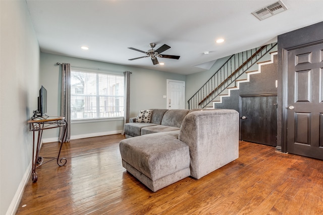 living room featuring hardwood / wood-style flooring and ceiling fan