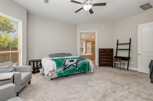 carpeted bedroom featuring ceiling fan and connected bathroom