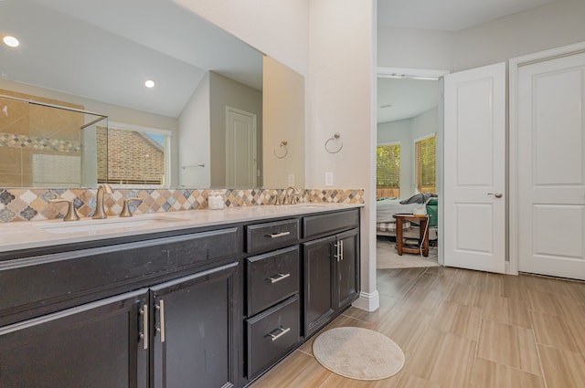 bathroom with walk in shower, vanity, and decorative backsplash